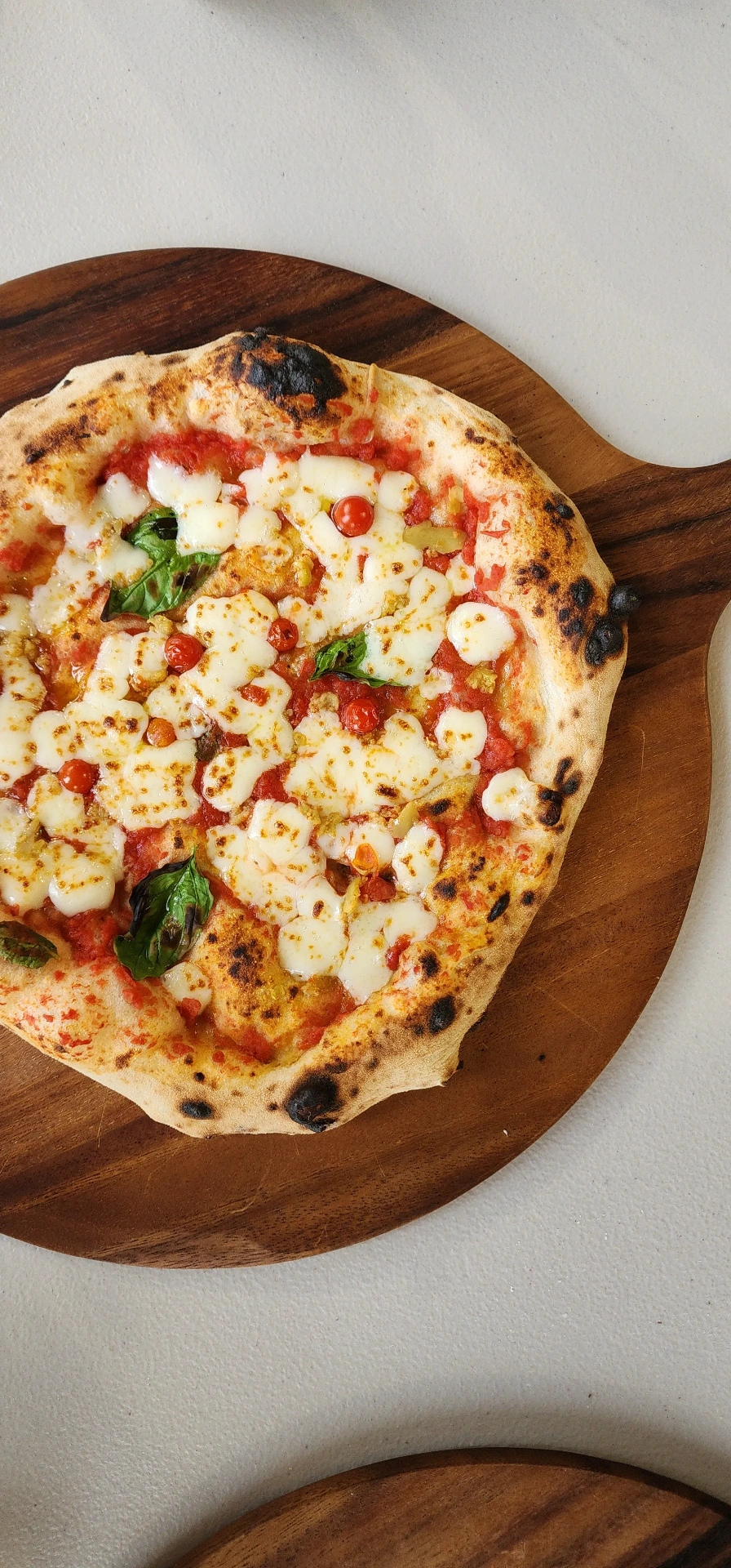 SR Pizza margherita with basil on a wooden board