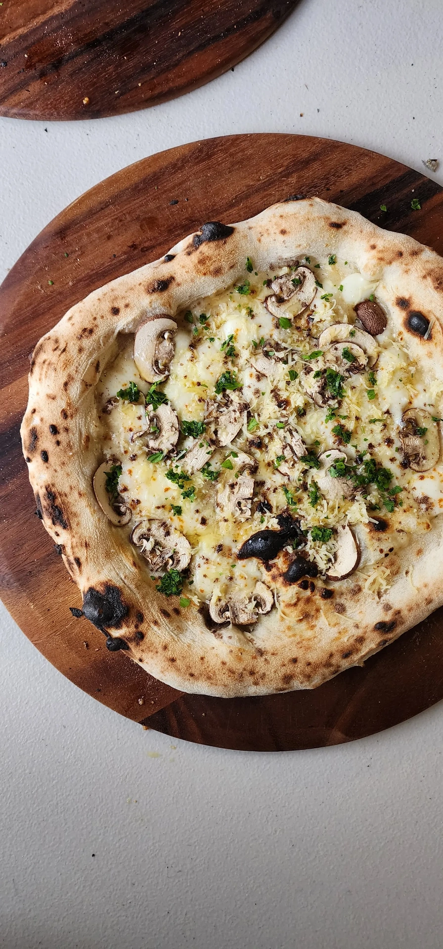 SR Pizza mushroom and truffle pizza on a wooden board