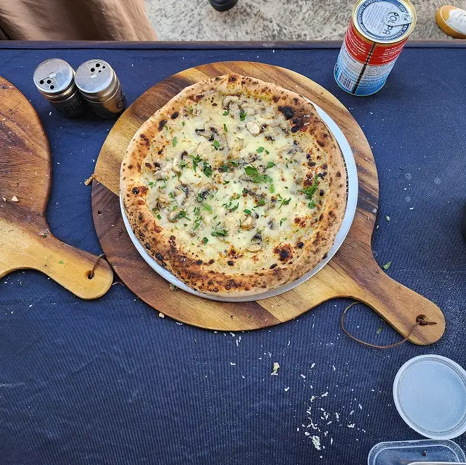 SR Pizza margherita-style pizza on a round wooden board
