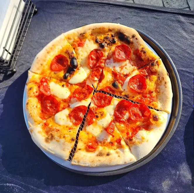 SR Pizza loaded pizza with olives and balsamic glaze