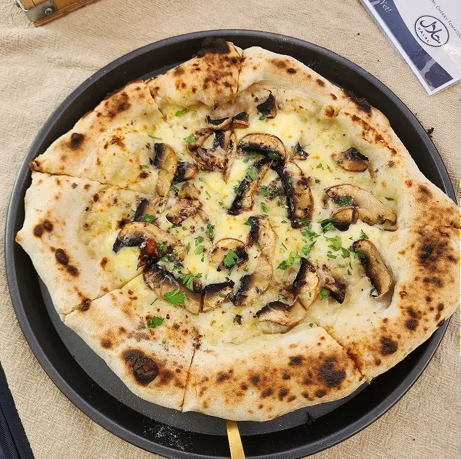 SR Pizza cheese pizza on a wooden board
